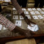 Election workers count ballot papers following a presidential election at