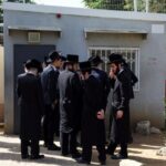 Ultra-Orthodox Jews line up at an Israeli draft office to