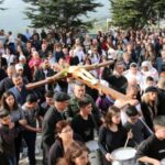 Christian worshippers take part in the Good Friday procession as