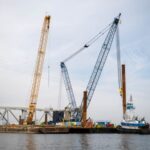 Barge cranes are shown near the collapsed Francis Scott Key