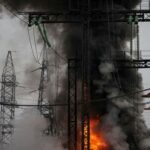 FILE PHOTO: Smoke and fire are seen near a high-voltage