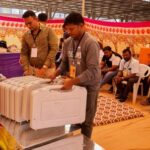 Election staff keeps Electronic Voting Machines (EVM)  on metal