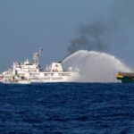 FILE PHOTO: Chinese Coast Guard vessels fire water cannons towards