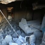 Palestinians inspect damage inside the Al-Ahli Arab Baptist Hospital in