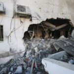 Palestinians inspect damage inside the Al-Ahli Arab Baptist Hospital in