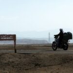 An Egyptian man rides his motorbike along a road in