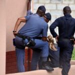 Police officers inspect the scene where kidnapped U.S. pastor, Josh