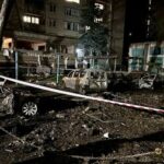 The wreckage of cars sit at the site of a