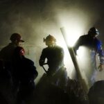 Rescuers work at the site of an apartment building hit