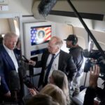 U.S President Donald Trump speaks to members of press onboard