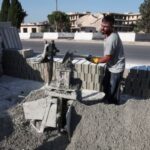 Maher Rajoub, a person involved in rebuilding destroyed houses, works
