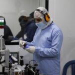 A worker supervises the manufacturing of medicines inside Reva Pharma