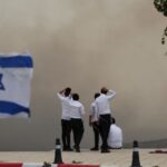 People look at smoke as wildfires broke out in central