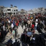 Palestinians search for casualties at the site of an Israeli