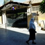 Druze woman walks near the Druze mosque in Jaramana