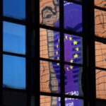 A banner depicting an European Union flag is reflected