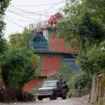 Security force personnel stand guard in front of Bilal Mosque
