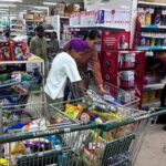 People shop for essential goods at a supermarket in Amritsar