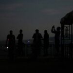 People record with their phones as India’s air defence system
