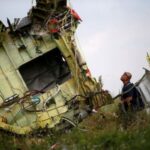 FILE PHOTO: Malaysian air crash investigator inspects crash site of