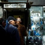 People gather at an ATM machine of Commercial Bank of