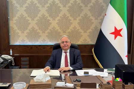 Syrian Finance Minister Yisr Barnieh attends an interview with Reuters