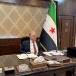 Syrian Finance Minister Yisr Barnieh attends an interview with Reuters