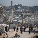 Palestinians make their way with belongings as they fled their