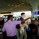 FILE PHOTO: A volunteer guides passengers to their respective gates