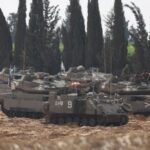 Israeli military vehicles are parked near the Israel-Gaza border, on