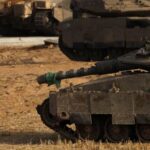 An Israeli soldier walks as he performs his morning prayers,