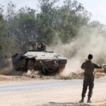 An Israeli tank operates near the Israel-Gaza border, on the
