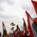 FILE PHOTO: People wave Indian flags in support of the