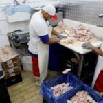 Chicken vendors work in a market in Sao Paulo