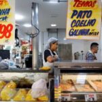 A chicken vendor works in a market in Sao Paulo