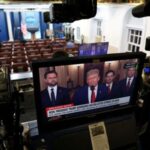 Member of the media report from the White House in