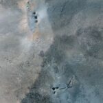 A closer satellite view shows holes and craters on a