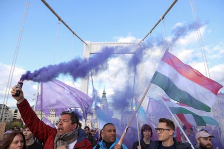 FILE PHOTO: People demonstrate after Hungarian parliament passed a law