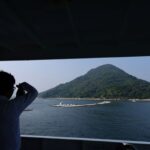 Rebun Kayo takes a photo of Ninoshima Island from a