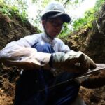 Rebun Kayo looks for the bone fragments unearthed at a