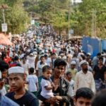 FILE PHOTO: Rohingya refugees gather at roadside kitchen market, at