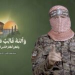 Hamas’ armed wing spokesperson, Abu Ubaida, speaks in this screen