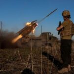 FILE PHOTO: Ukrainian servicemen fire a Grad MLRS towards Russian
