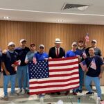 U.S. citizens released from Venezuela pose for a photo holding