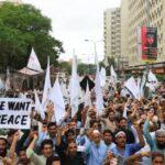 People rally to protest against the militant violence and demanding
