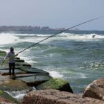 A view shows an Alexandrian citizen fishing on the corniche
