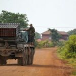 A Cambodian military personnel stands on a BM-21 Grad multiple