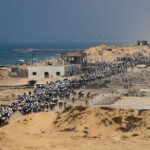 Palestinians gather for aid supplies in Beit Lahia