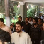 FILE PHOTO: Policemen escort tribal chief Sher Baz Satakzai, in