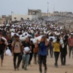 FILE PHOTO: Palestinians receive aid supplies in Beit Lahia